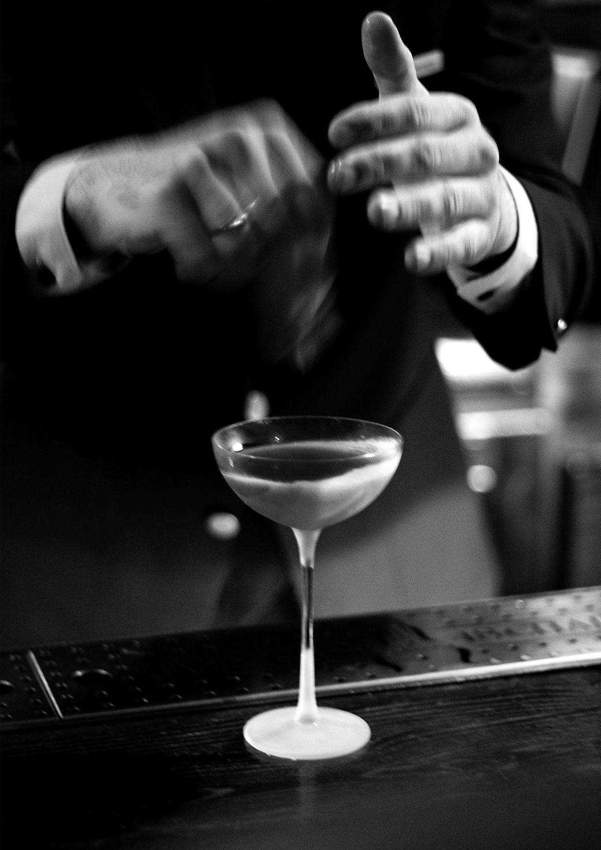 Sophisticated cocktail with bartender hands in motion